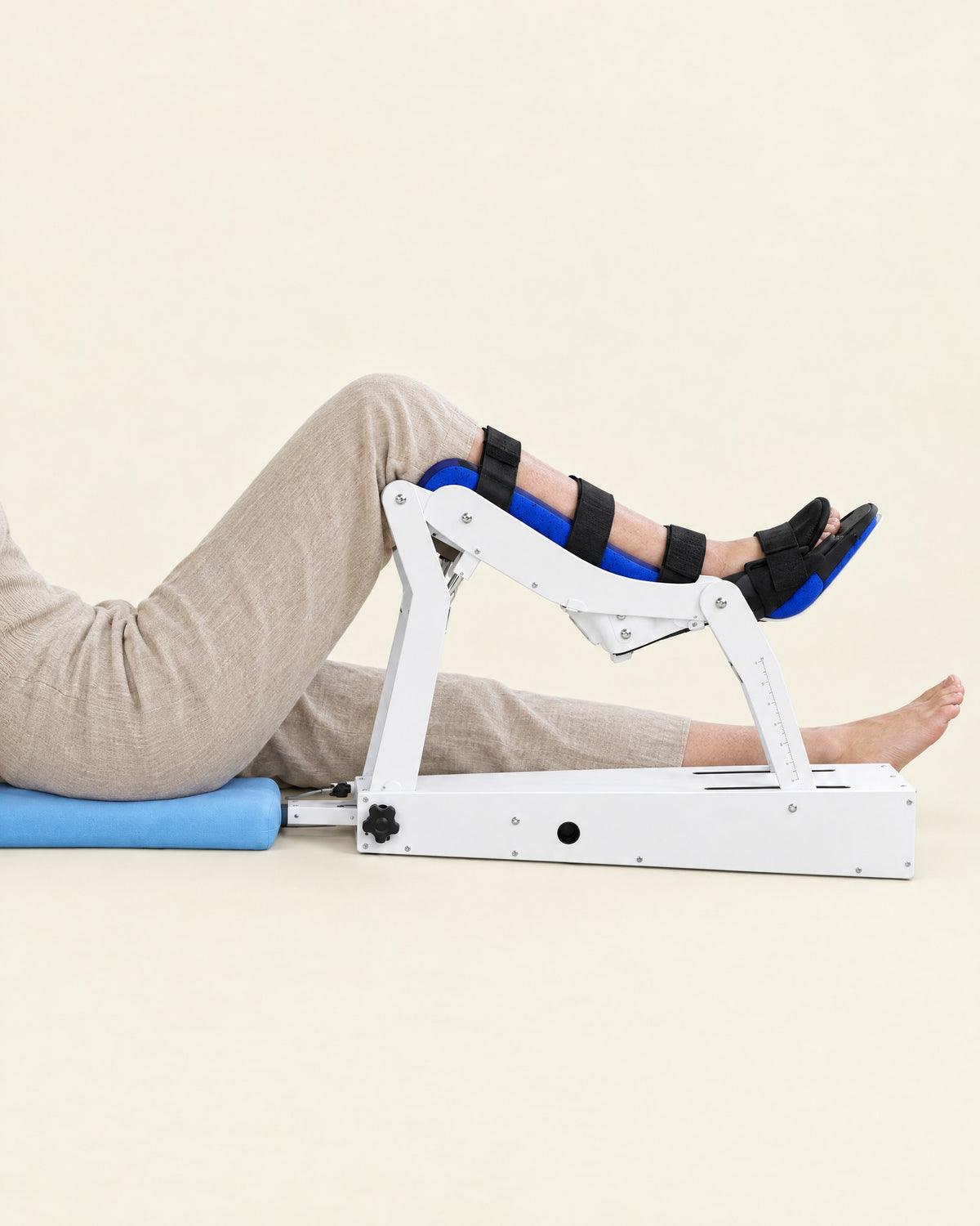 A leg strapped into Glide, sitting on the floor-level cushion