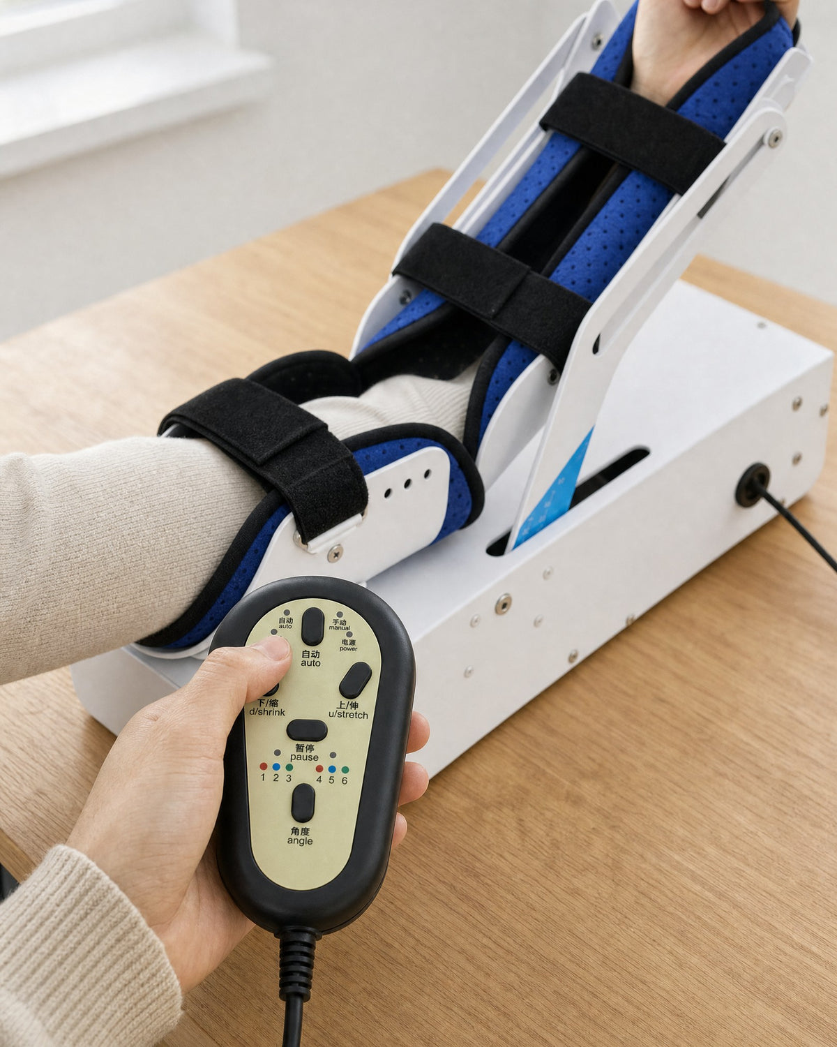 A hand holding the wired remote
