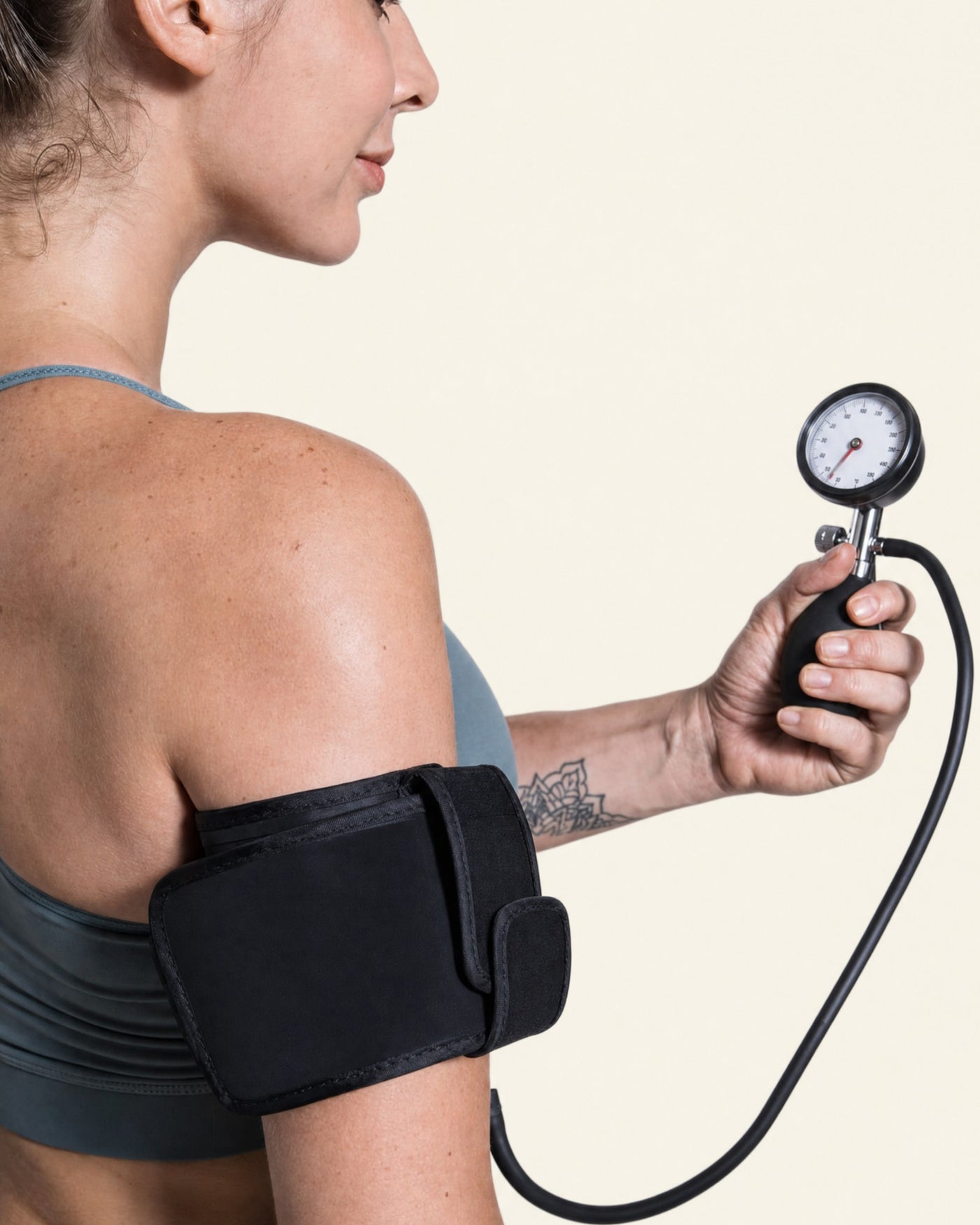 Holtrow Surge cuff worn on the arm with the analog pressure gauge and squeeze bulb