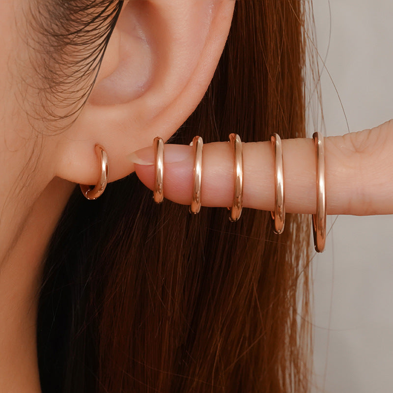 Cercle 18K huggie hoop earrings silver worn