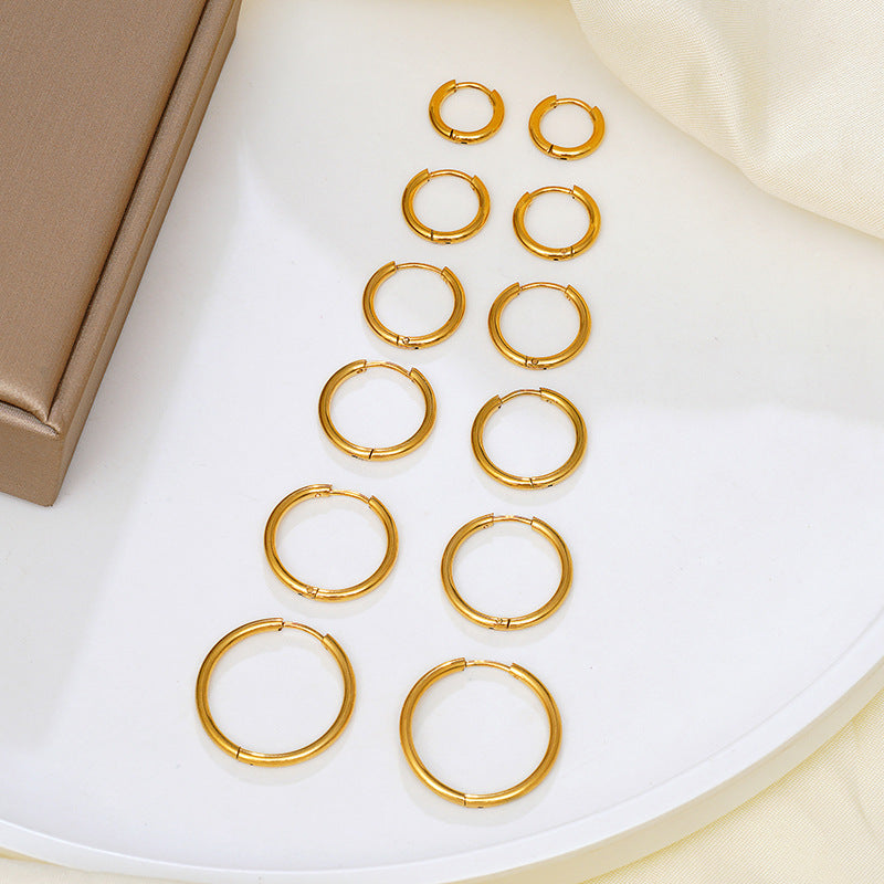 Cercle 18K huggie hoop earrings silver flat lay