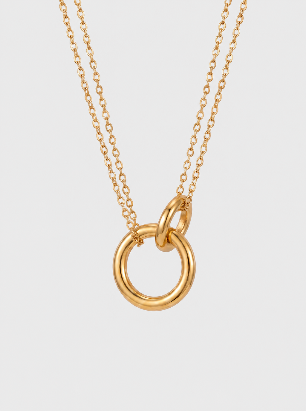 Halo 18K gold pendant necklace on soft grey background