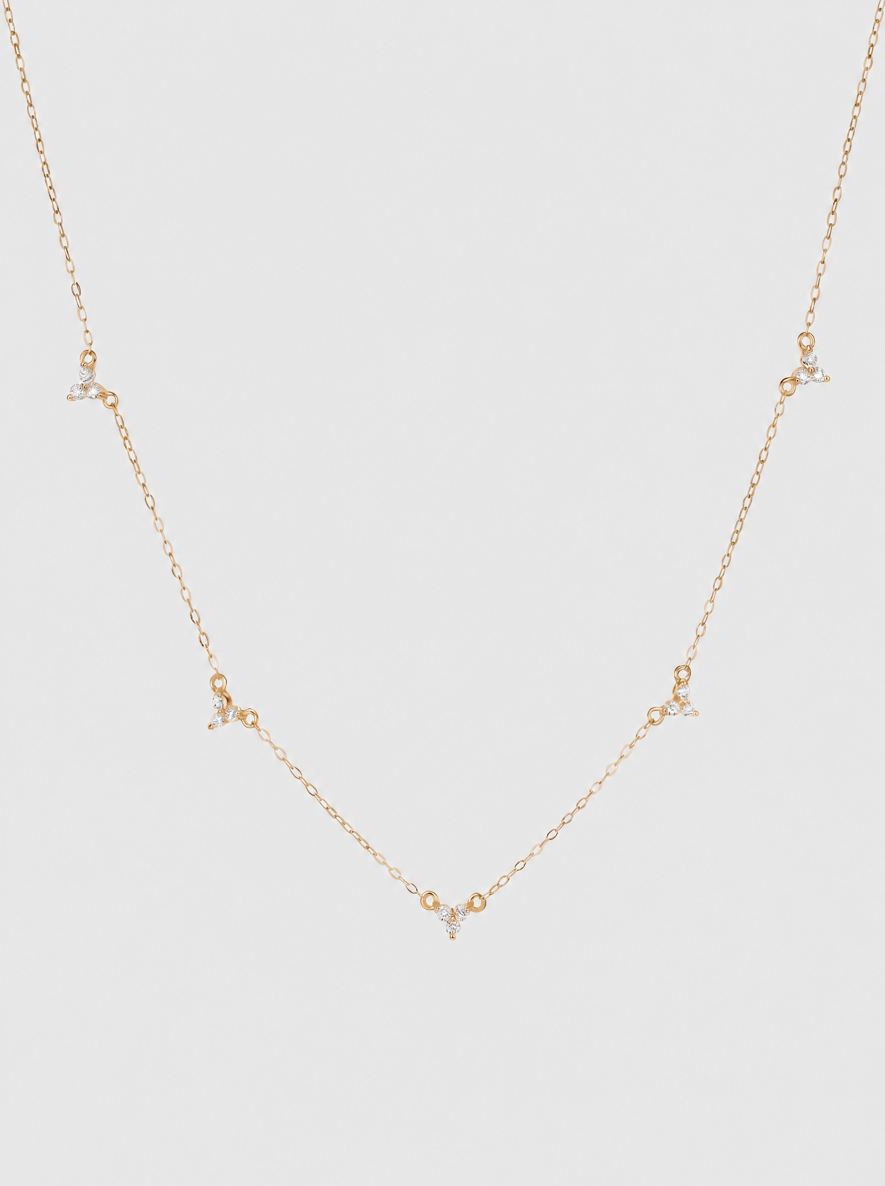 Stella 18K star necklace on soft grey background