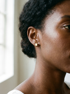 Carre gold cube stud earring worn on the ear