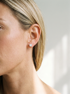 Carre silver cube stud earring worn on the ear