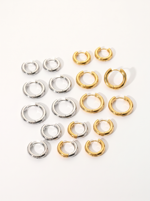 Cercle 18K gold huggie hoop earrings on bright clean white background
