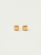 Carre chunky square gold cube stud earrings on warm off-white background