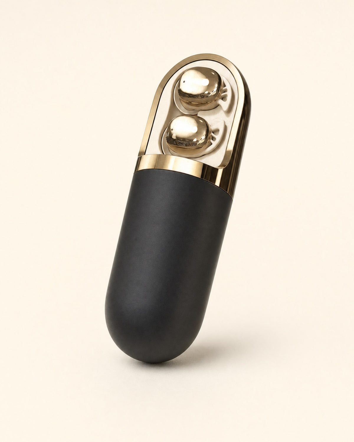 Holtrow Lull wind-down capsule — matte black case with a bronze cap and two rollers