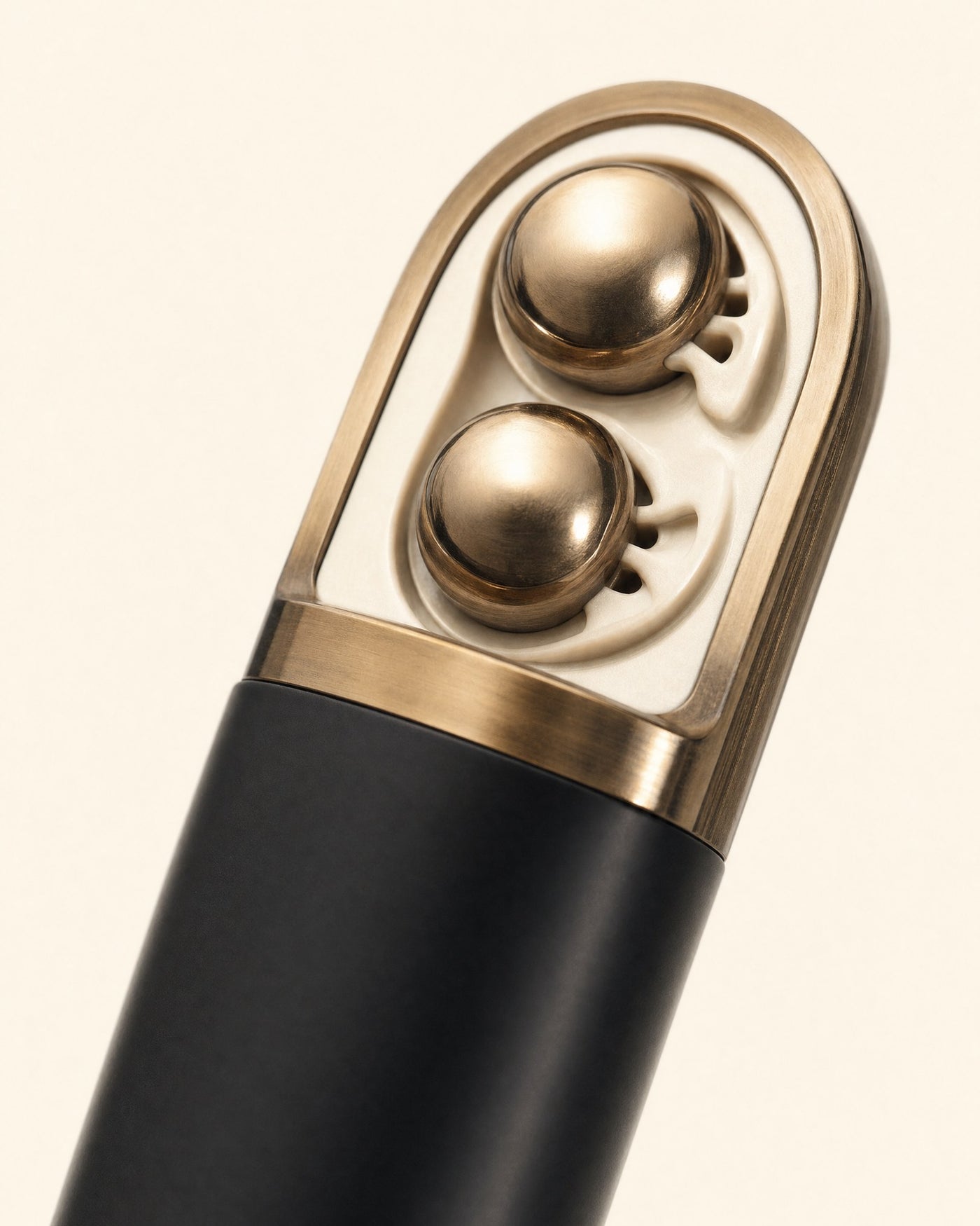 Close-up of the two bronze rollers set into the cap