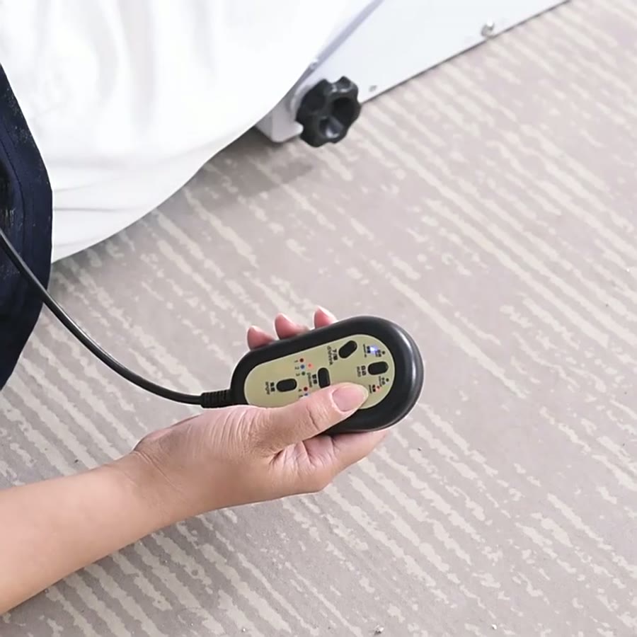 A hand holding the wired remote