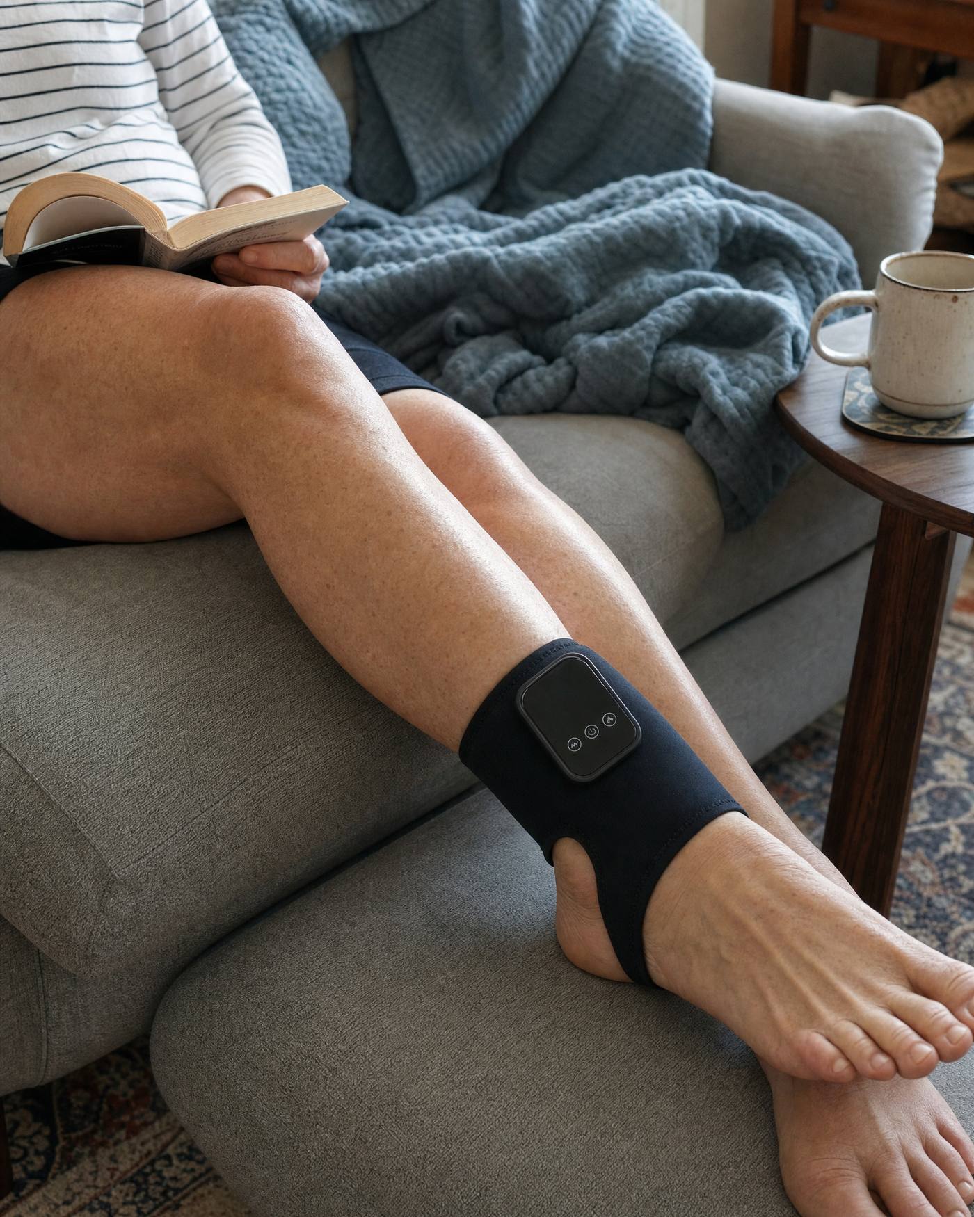 Legs stretched along a sofa, reading, wrap on the upper ankle