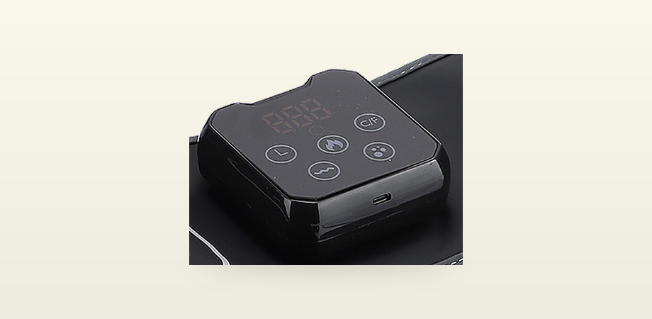 The control pod: timer, heat, unit switch, vibration and air keys around a temperature readout, with a USB-C port on the lower edge